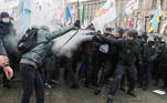 Ukrainian law enforcement officers use tear gas as they block demonstrators during a rally of entrepreneurs and representatives of small businesses amid the coronavirus disease (COVID-19) outbreak in Independence Square in Kyiv, Ukraine December 15, 2020. Entrepreneurs gathered to demand governmental support and to protest against restrictive measures introduced to curb the spread of the coronavirus. REUTERS/Gleb Garanich