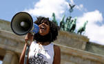 A woman holds a megaphone during a protest against the death in Minneapolis police custody of African-American man George Floyd, at Brandenburg Gate in Berlin, Germany, May 31, 2020. REUTERS/Christian Mang TPX IMAGES OF THE DAY