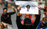 A protester holds a placard as he takes part in a protest against the death in Minneapolis police custody of African-American man George Floyd, in central Brussels, Belgium June 1, 2020. REUTERS/Francois Lenoir