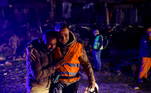 Volunteers share an emotional moment as they take part in a rescue operation following an earthquake in Hatay, Turkey February 8, 2023. REUTERS/Kemal Aslan
