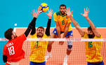 Tokyo 2020 Olympics - Volleyball - Men's Pool B - Brazil v The Russian Olympic Committee - Ariake Arena, Tokyo, Japan – July 28, 2021. Egor Kliuka of the Russian Olympic Committee in action with Bruno of Brazil and Lucas of Brazil. REUTERS/Carlos Garcia Rawlins