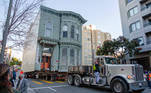 The 139-year-old Victorian house known as the Englander House is hoisted on a flat bed and pulled down Franklin Street towards its new location six blocks away, as the original site is to be used to build a 48-unit, eight-story apartment building, in San Francisco, California, U.S. February 21, 2021. REUTERS/Brittany Hosea-Small TPX IMAGES OF THE DAY