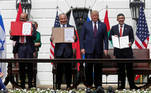 Bahrain’s Foreign Minister Abdullatif Al Zayani, Israel's Prime Minister Benjamin Netanyahu and United Arab Emirates (UAE) Foreign Minister Abdullah bin Zayed display their copies of signed agreements while U.S. President Donald Trump looks on as they participate in the signing ceremony of the Abraham Accords, normalizing relations between Israel and some of its Middle East neighbors, in a strategic realignment of Middle Eastern countries against Iran, on the South Lawn of the White House in Washington, U.S., September 15, 2020. REUTERS/Tom Brenner TPX IMAGES OF THE DAY