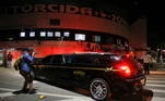 A man takes a picture of the vehicle transporting Brazilian soccer legend Pele's body, at the Vila Belmiro stadium in Santos, Brazil, January 2, 2023. REUTERS/Diego Vara