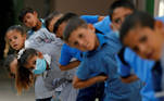 Palestinian students exercise at their school as schools reopen gradually amid the coronavirus disease (COVID-19) outbreak, in Susya village in the Israeli-occupied West Bank September 7, 2020. REUTERS/Mussa Qawasma TPX IMAGES OF THE DAY