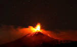 Large streams of red hot lava shoot into the night sky as Mount Etna, Europe's most active volcano, leaps into action, seen from the village of Fornazzo, Italy, February 3, 2021. Picture taken February 3, 2021. REUTERS/Antonio Parrinello