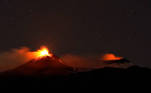 Large streams of red hot lava shoot into the night sky as Mount Etna, Europe's most active volcano, leaps into action, seen from the village of Fornazzo, Italy, February 3, 2021. Picture taken February 3, 2021. REUTERS/Antonio Parrinello