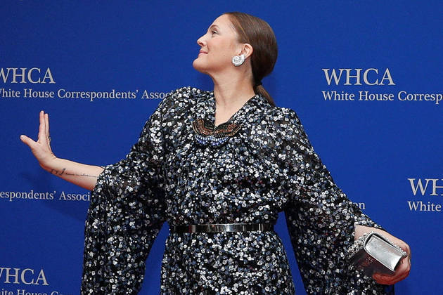 Actor Drew Barrymore poses as she arrives on the red carpet for the annual White House Correspondents' Association Dinner in Washington, U.S., April 30, 2022. REUTERS/Tom Brenner