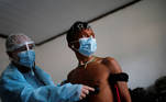 A member of Brazilian Armed Forces medical team examines a man from the indigenous Yanomami ethnic group, amid the spread of the coronavirus disease (COVID-19), at the 4th Surucucu Special Frontier Platoon of the Brazilian army in the municipality of Alto Alegre, state of Roraima, Brazil July 1, 2020. REUTERS/Adriano Machado