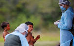 SENSITIVE MATERIAL. THIS IMAGE MAY OFFEND OR DISTURB A member of Brazilian Armed Forces medical team examines a woman from the indigenous Yanomami ethnic group, amid the spread of the coronavirus disease (COVID-19), at the Surucucu region in the municipality of Alto Alegre, state of Roraima, Brazil July 1, 2020. REUTERS/Adriano Machado