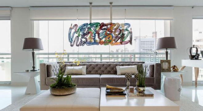Sala de estar com cores neutras e lustre colorido