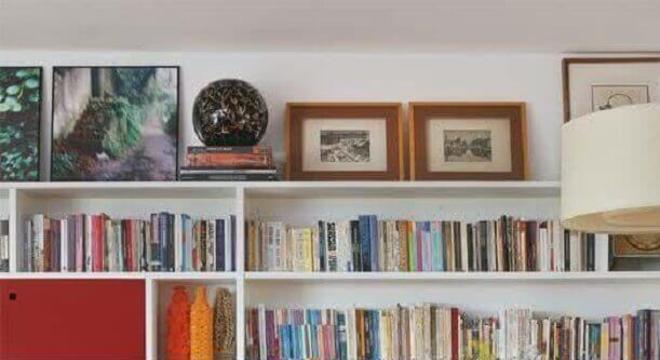 sala de jantar decorada com estante para livros branca 