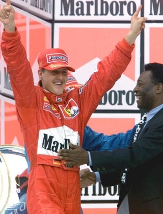 F1-BRAZIL-SCHUMACHER-PELE:SAP15-20000326-SAO PAULO, BRAZIL: Soccer legend Pele (R) congratulates former German Formula One world champion Michael Schumacher (L) of Ferrari on the podium after Schumacher won the Brazilian Formula One Grand Prix in Sao Paulo, Brazil on Sunday 26 March 2000. (ELECTRONIC IMAGE) EPA PHOTO DPA/STR/kn-fob