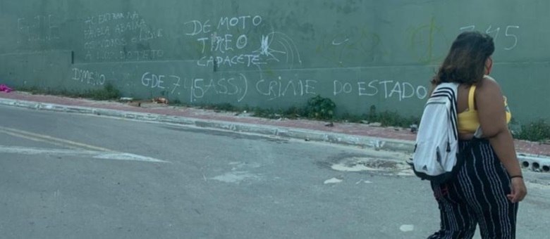 Mulher caminha em região dominada pela facção criminosa GDE, em Fortaleza (Reprodução/Record TV)
