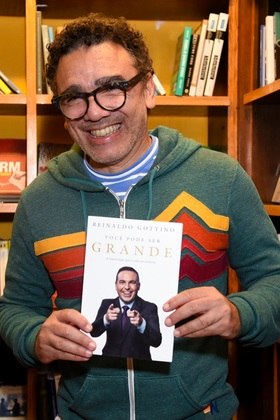 O cantor Simoninha foi fotografado sorridente no lançamento do livro de Gottino