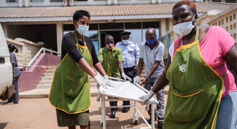 Equipe médica prepara uma maca para receber vítima de explosão em Kampala